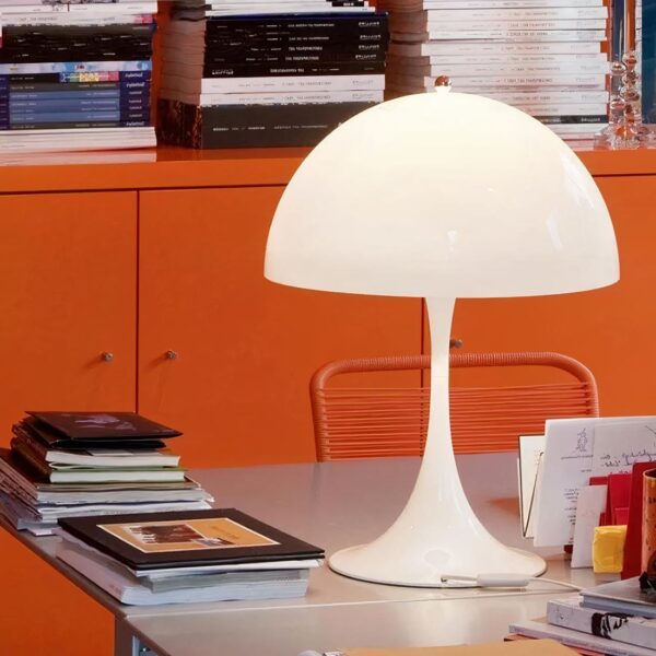 lampe de chevet scandinave ronde posé sur une table avec des livres et document