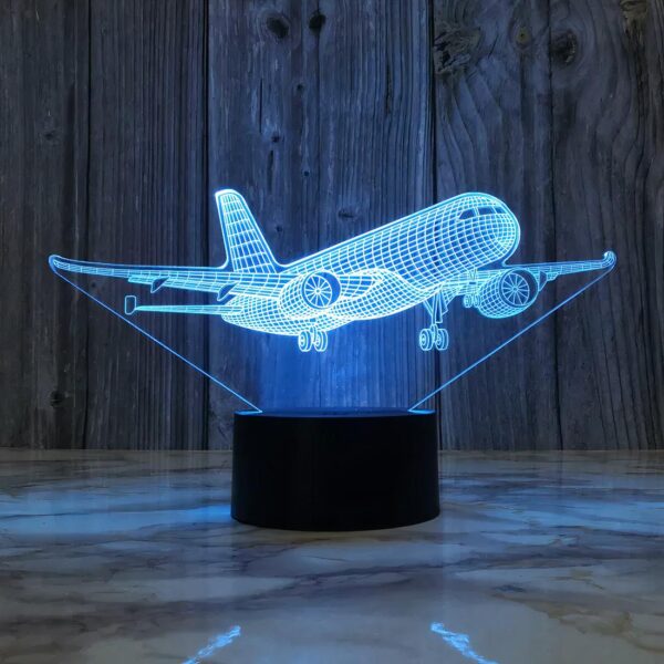 Lampe de chevet led en forme d'avion posé sur une table