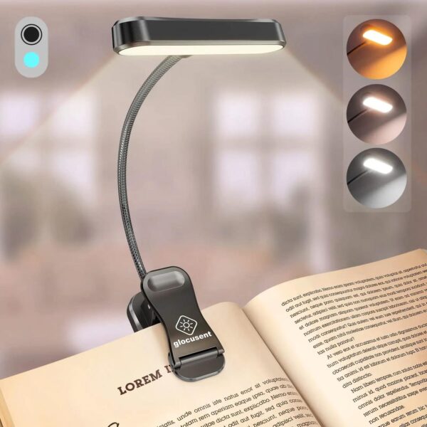Lampe de chevet à pince avec variateur de luminosité posé sur un livre