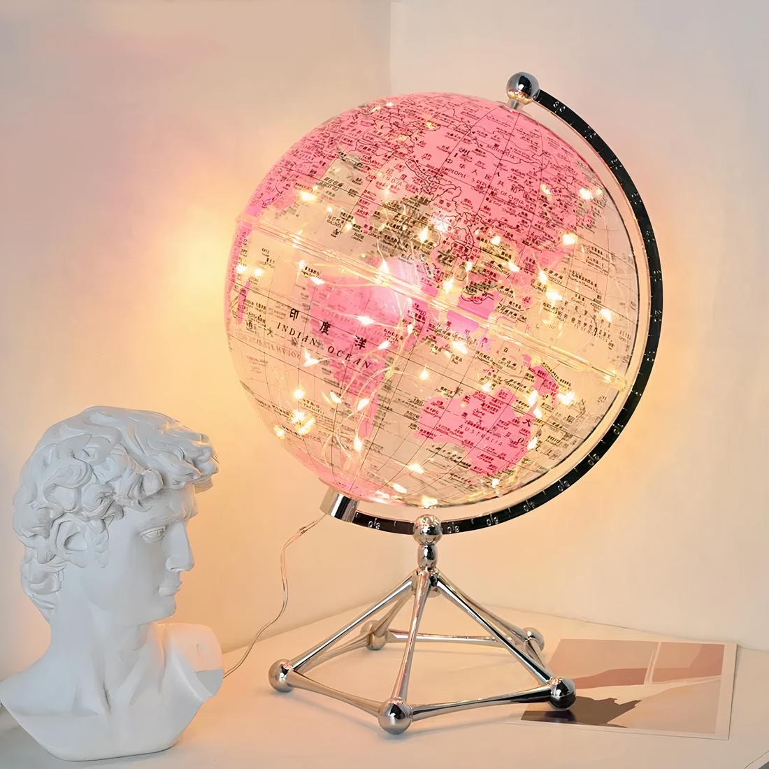 Lampe de chevet lobe terrestre rose posé sur une table